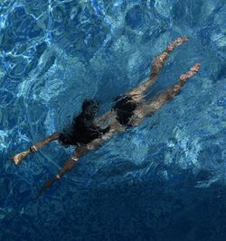 High angle view of woman swimming in pool