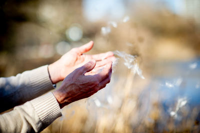 Close-up of hands holding water