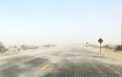 Road by landscape against clear sky