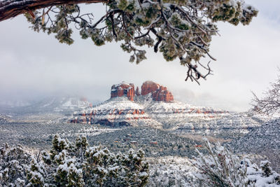 Scenic view of cathedral rock with snow in sedona, arizona.