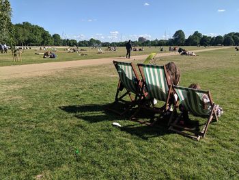 Panoramic view of people on field against sky