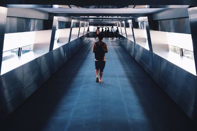 Full length of woman standing on footbridge