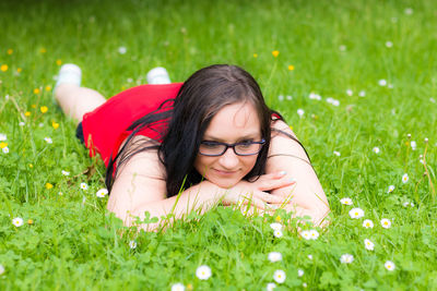 Portrait of happy girl lying on grass