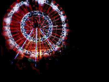 Illuminated ferris wheel at night