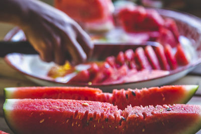 Close-up of person preparing food in plate