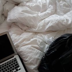 High angle view of mobile phone on bed