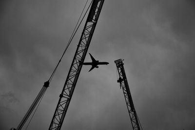 Low angle view of crane against sky