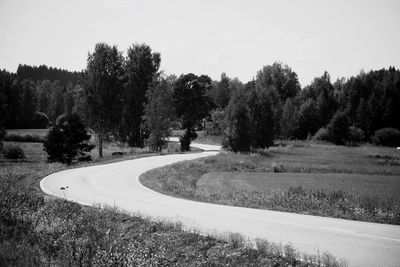 Road amidst trees against sky