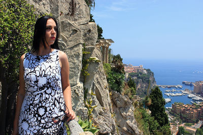 Woman looking away while standing on cliff