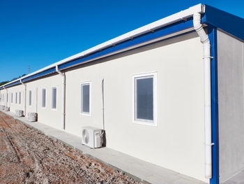 Low angle view of building against clear blue sky