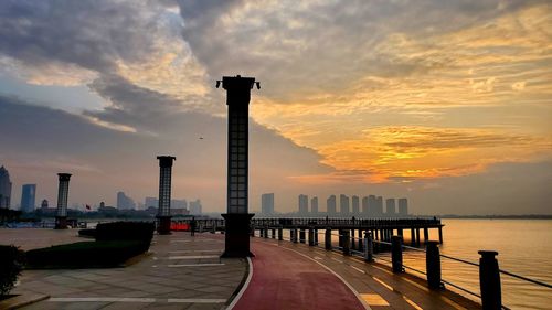 Pier over sea against sky during sunset