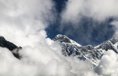 Low angle view of snowcapped mountain against sky