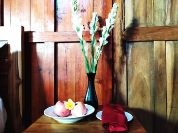 Flower vase on table at home