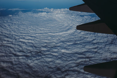 Airplane wing against sky