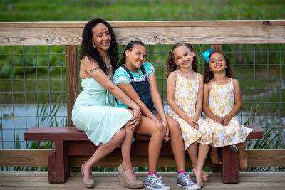 Portrait of a smiling ladies sitting outdoors