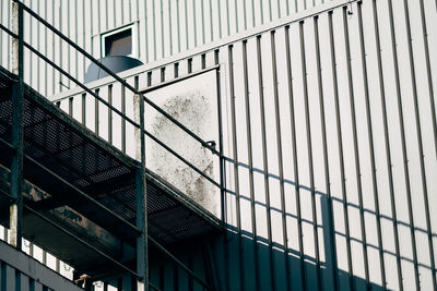 Low angle view of walkway connected to building on sunny day