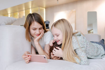 Young woman using mobile phone at home