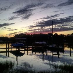 Pier on lake at sunset