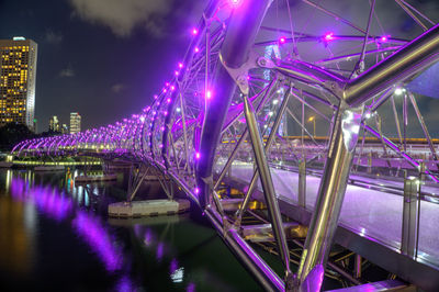 Illuminated bridge against sky at night