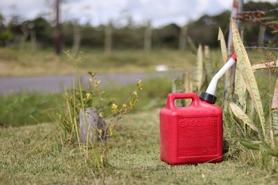 Close-up of red mailbox on field