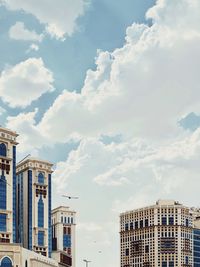 Low angle view of buildings against cloudy sky