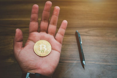 Close-up of hand holding bit coin