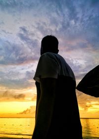 Man standing against sky during sunset