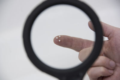 Cropped hand holding magnifying glass