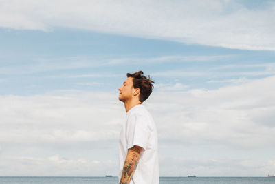 Man looking at sea against sky