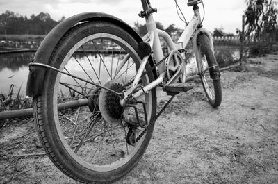 Close-up of bicycle parked on field