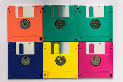 Directly above shot of multi colored floppy disks arranged on gray background