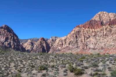 Scenic view of rocky mountains against clear blue sky