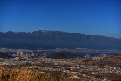 Scenic view of mountains against clear blue sky