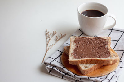 Coffee cup and tea on table