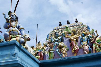 Low angle view of statues against sky