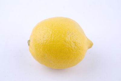 Close-up of orange apple against white background