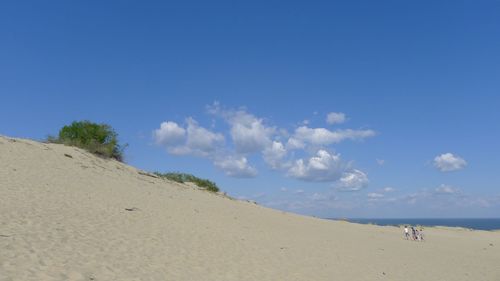 Scenic view of beach against blue sky