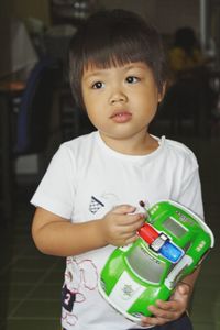 Close-up of cute baby boy holding toy car