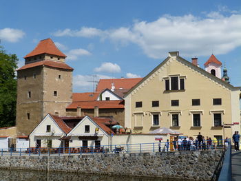 Houses by street in town against sky