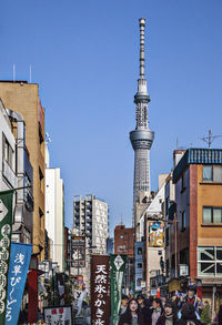 Buildings by tokyo sky tree against clear blue sky
