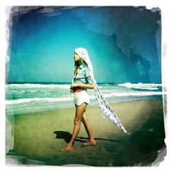 Rear view of woman standing on beach