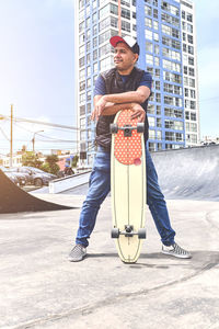 Full length of young man standing on street in city