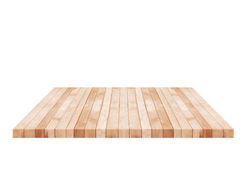 Close-up of wooden table against white background