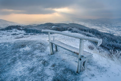 Scenic view of snow covered field against sky