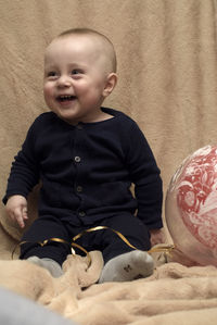 Cute baby girl sitting on sofa