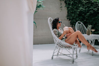 Woman sitting on chair at park