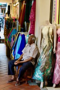 Woman sitting on chair in store