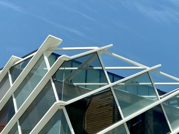 Low angle view of modern building against clear blue sky