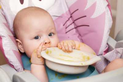 High angle view of cute baby boy with food