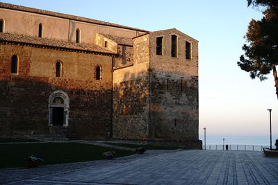 Building by street against clear sky